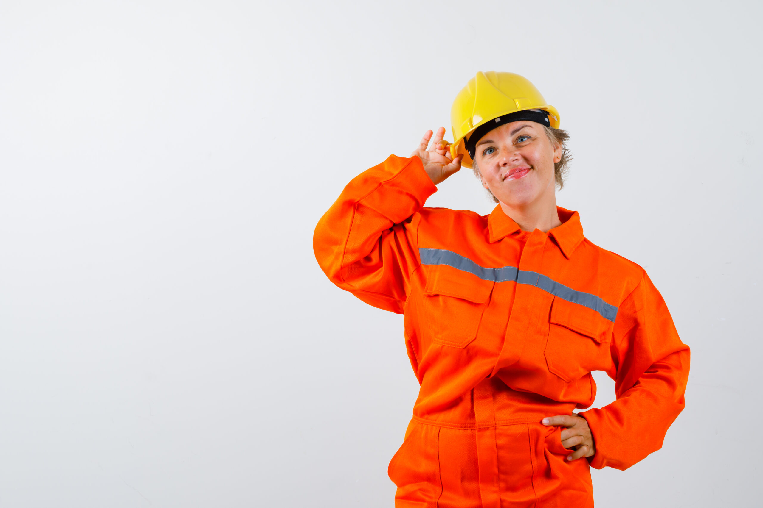 mature firewoman posing while standing in uniform and looking confident , front view.